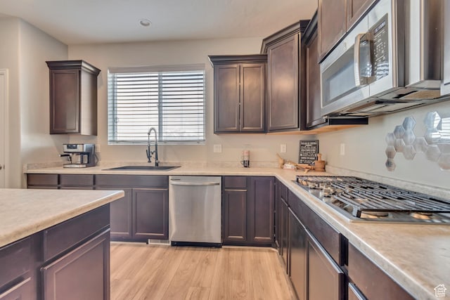 15191 S Ronaldo Ln, Herriman, UT 84096 - kitchen featuring stainless steel appliances, light wood finished floors, light countertops, and a sink
