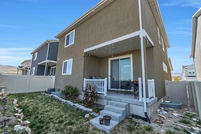 15191 S Ronaldo Ln, Herriman, UT 84096 - back of property with stucco siding and fence