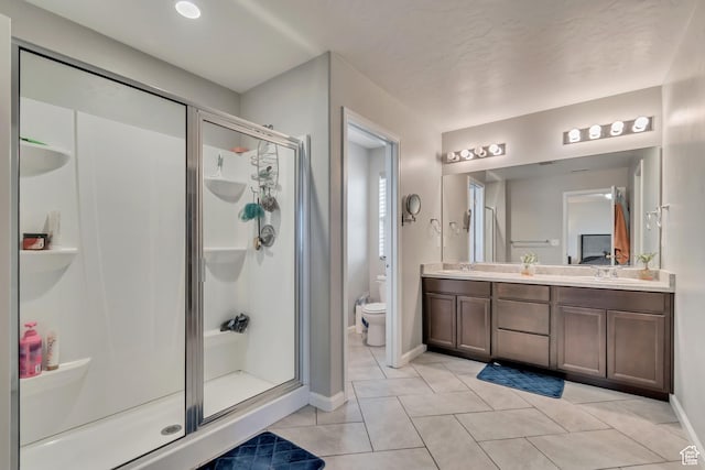 15191 S Ronaldo Ln, Herriman, UT 84096 - bathroom with tile patterned floors, toilet, double vanity, and a stall shower
