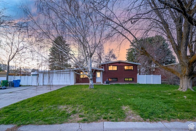 1171 E Hyland Lake Dr S, Murray, UT 84121 - view of front facade with a garage, a yard, fence, brick siding, and driveway