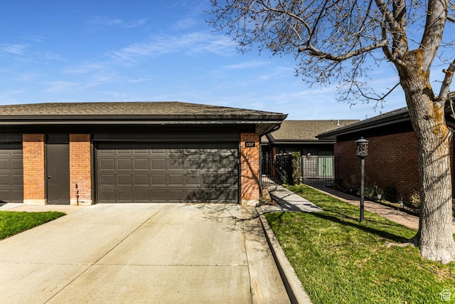 1357 E Ridgewood Ln S, Bountiful, UT 84010 - view of front facade featuring a garage, brick siding, driveway, and fence