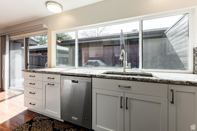 1357 E Ridgewood Ln S, Bountiful, UT 84010 - kitchen with light stone counters, white cabinetry, dark wood finished floors, stainless steel dishwasher, and a sink