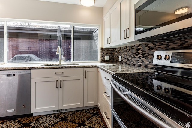 1357 E Ridgewood Ln S, Bountiful, UT 84010 - kitchen featuring white cabinets, plenty of natural light, a sink, appliances with stainless steel finishes, and backsplash