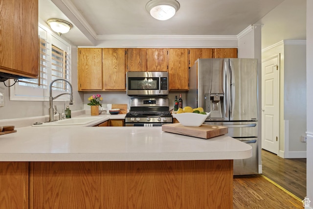 3168 W Ryan Dr, Taylorsville, UT 84129 - kitchen featuring stainless steel appliances, brown cabinets, light countertops, and a sink