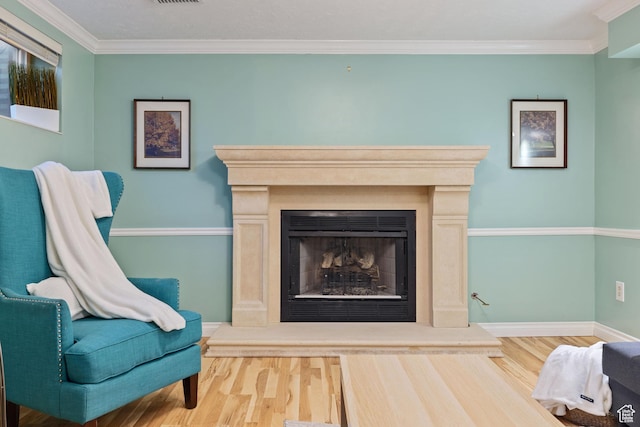 3168 W Ryan Dr, Taylorsville, UT 84129 - sitting room with a fireplace with raised hearth, baseboards, ornamental molding, and wood finished floors