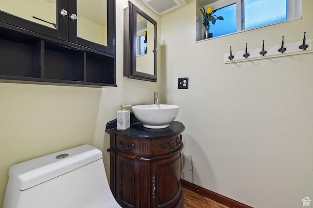 3168 W Ryan Dr, Taylorsville, UT 84129 - half bath featuring visible vents, toilet, vanity, and baseboards