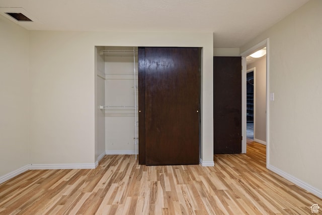 3168 W Ryan Dr, Taylorsville, UT 84129 - unfurnished bedroom with a closet, light wood finished floors, baseboards, and visible vents