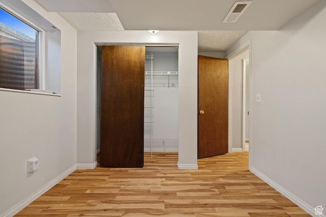 3168 W Ryan Dr, Taylorsville, UT 84129 - unfurnished bedroom featuring light wood-type flooring, a closet, baseboards, and visible vents