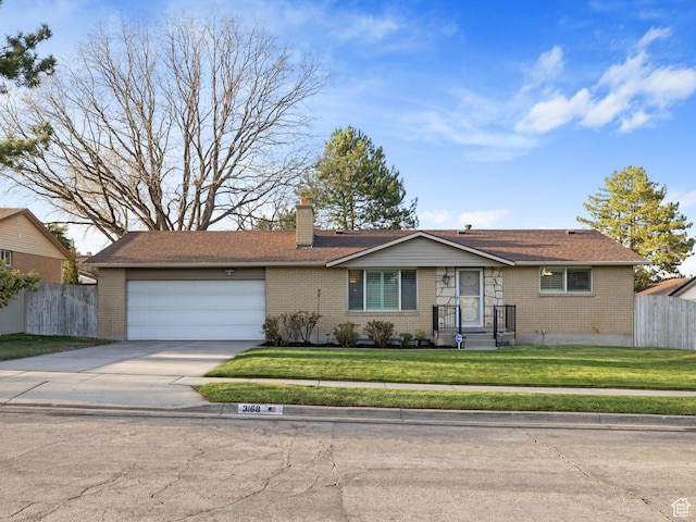 3168 W Ryan Dr, Taylorsville, UT 84129 - ranch-style house with brick siding, driveway, fence, and an attached garage