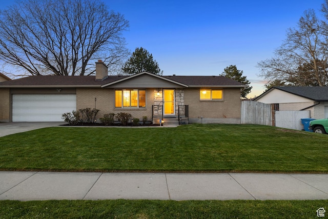 3168 W Ryan Dr, Taylorsville, UT 84129 - single story home with a lawn, fence, brick siding, an attached garage, and concrete driveway
