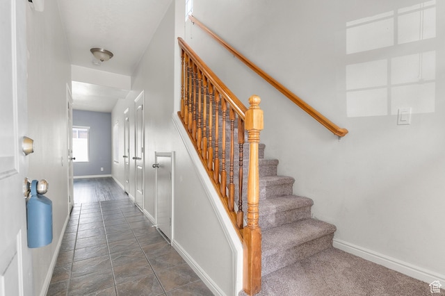 stairway featuring baseboards