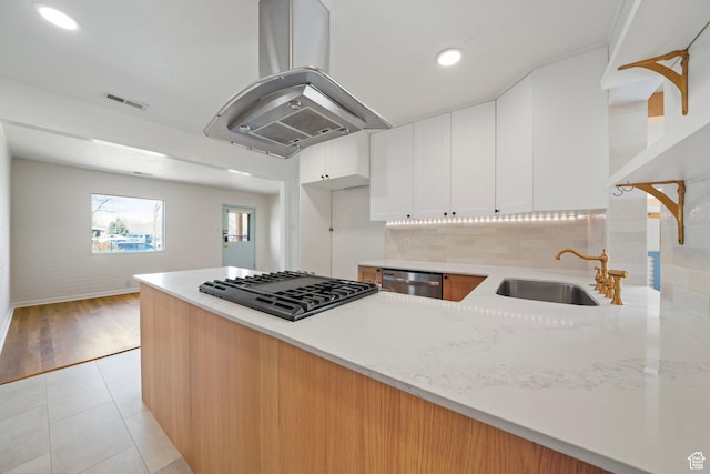 1489 W 300 S, Salt Lake City, UT 84104 - kitchen featuring stainless steel dishwasher, visible vents, island range hood, a sink, and stovetop
