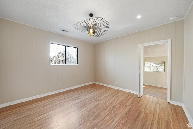 1489 W 300 S, Salt Lake City, UT 84104 - unfurnished room with light wood-style flooring, a textured ceiling, baseboards, and visible vents