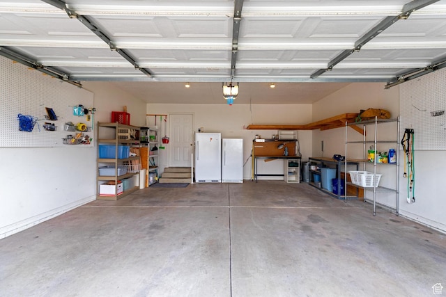 1181 W 4550 S Unit 26, Riverdale, UT 84405 - garage featuring freestanding refrigerator, a garage door opener, and a workshop area