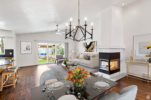1181 W 4550 S Unit 26, Riverdale, UT 84405 - living area featuring dark wood-style floors, a tiled fireplace, ceiling fan, high vaulted ceiling, and baseboards