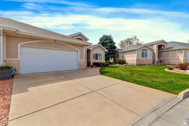 1181 W 4550 S Unit 26, Riverdale, UT 84405 - ranch-style home featuring concrete driveway, a front lawn, brick siding, an attached garage, and stucco siding