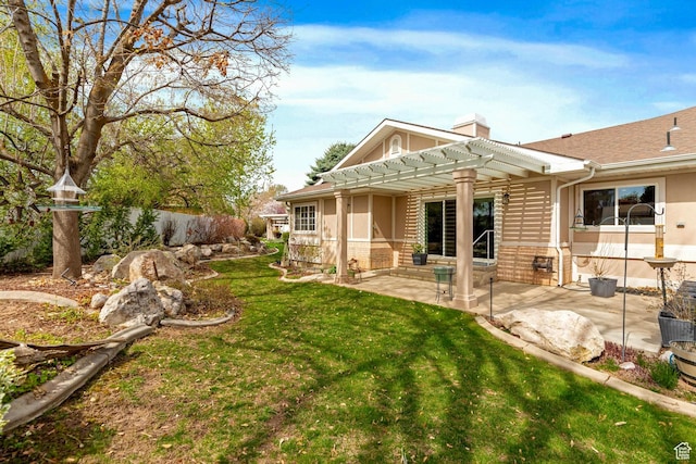 1181 W 4550 S Unit 26, Riverdale, UT 84405 - back of house with a pergola, a patio area, a chimney, a yard, and brick siding