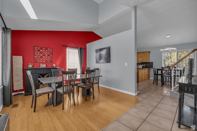 358 W Bricker Rd, Draper, UT 84020 - dining area featuring light wood-style floors, baseboards, vaulted ceiling, and a wealth of natural light