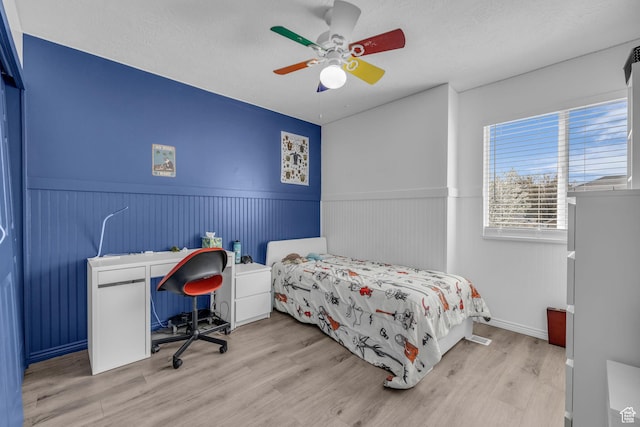 358 W Bricker Rd, Draper, UT 84020 - bedroom with wainscoting, a textured ceiling, a ceiling fan, and wood finished floors