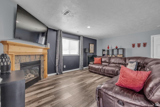 358 W Bricker Rd, Draper, UT 84020 - living room with visible vents, baseboards, a textured ceiling, a fireplace, and wood finished floors