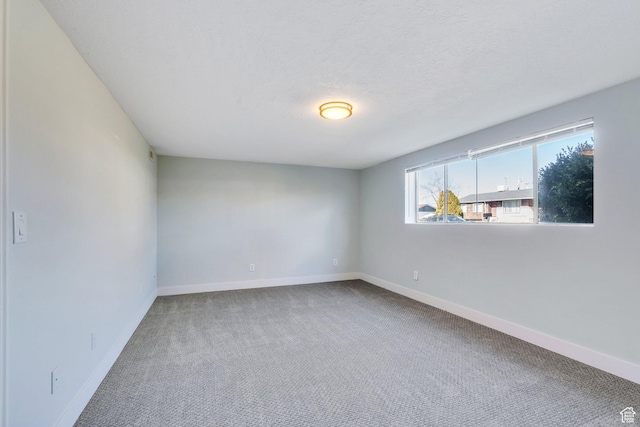 794 N Amethyst St, Layton, UT 84041 - spare room featuring a textured ceiling, carpet flooring, and baseboards