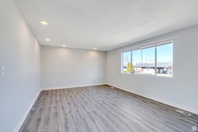 794 N Amethyst St, Layton, UT 84041 - unfurnished room featuring visible vents, baseboards, recessed lighting, and wood finished floors