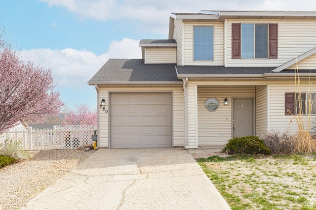 280 N Beacon Dr W, Cedar City, UT 84720 - view of front facade with an attached garage, fence, a shingled roof, and driveway