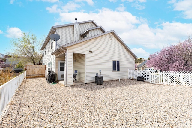 280 N Beacon Dr W, Cedar City, UT 84720 - back of property featuring a fenced backyard, a gate, cooling unit, and a patio