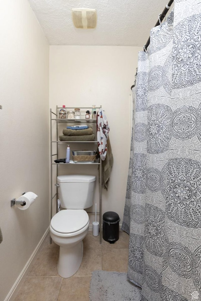 280 N Beacon Dr W, Cedar City, UT 84720 - bathroom featuring toilet, tile patterned flooring, baseboards, and a textured ceiling