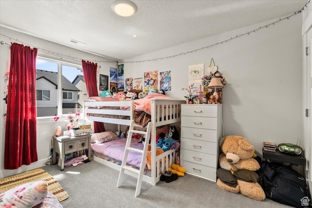carpeted bedroom with visible vents, a textured ceiling, and lofted ceiling