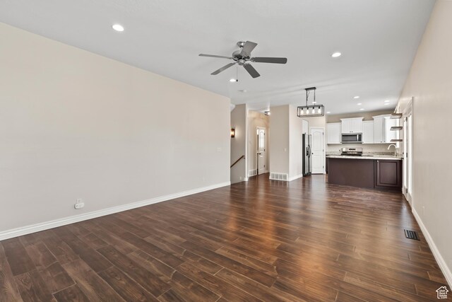 763 S Silver Leaf Dr, Mapleton, UT 84664 - unfurnished living room featuring visible vents, baseboards, a ceiling fan, recessed lighting, and dark wood-type flooring