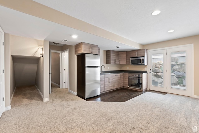 763 S Silver Leaf Dr, Mapleton, UT 84664 - kitchen featuring baseboards, a sink, dark carpet, dark countertops, and stainless steel appliances