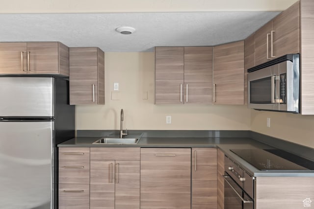 763 S Silver Leaf Dr, Mapleton, UT 84664 - kitchen featuring appliances with stainless steel finishes, a sink, modern cabinets, and dark countertops