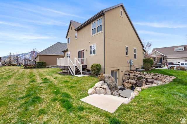 763 S Silver Leaf Dr, Mapleton, UT 84664 - rear view of house featuring a yard, a wooden deck, and stucco siding