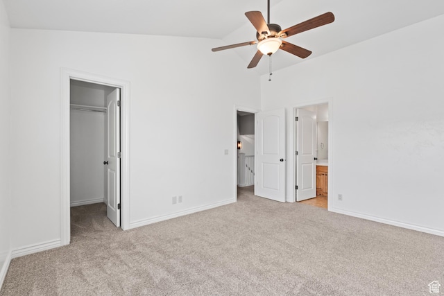 763 S Silver Leaf Dr, Mapleton, UT 84664 - unfurnished bedroom featuring baseboards, a walk in closet, light colored carpet, and vaulted ceiling