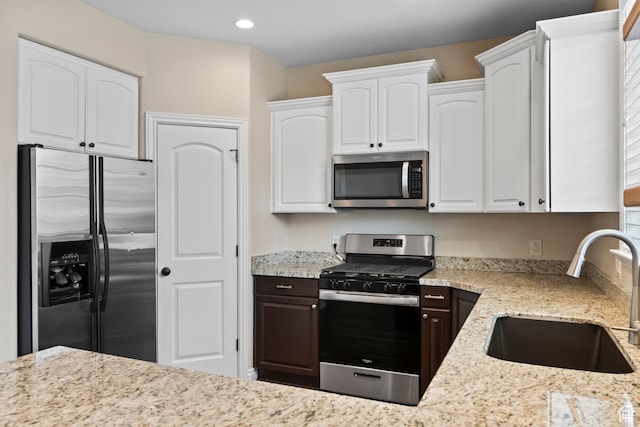 763 S Silver Leaf Dr, Mapleton, UT 84664 - kitchen featuring a sink, appliances with stainless steel finishes, light stone counters, and white cabinetry