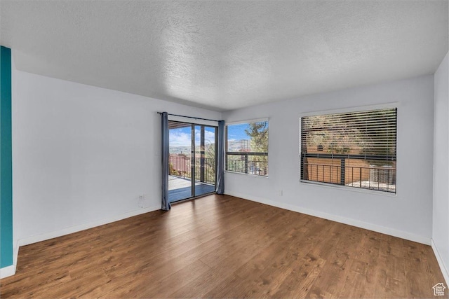 empty room featuring baseboards and wood finished floors