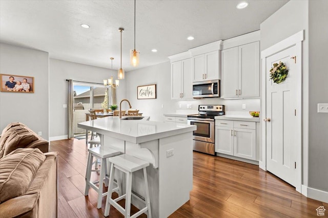 249 N 590 E, Vineyard, UT 84059 - kitchen with an island with sink, dark wood-style flooring, a sink, stainless steel appliances, and open floor plan