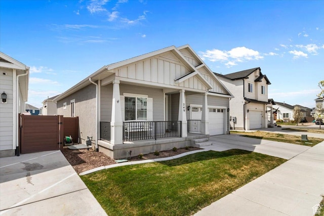 249 N 590 E, Vineyard, UT 84059 - view of front facade featuring a front yard, covered porch, board and batten siding, concrete driveway, and a gate