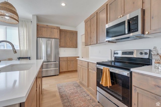 929 S 950 W, American Fork, UT 84003 - kitchen featuring recessed lighting, light wood-style flooring, light countertops, stainless steel appliances, and a sink