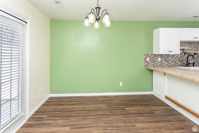187 E 2300 N, North Ogden, UT 84414 - unfurnished dining area featuring a sink, a wealth of natural light, a chandelier, and dark wood-type flooring