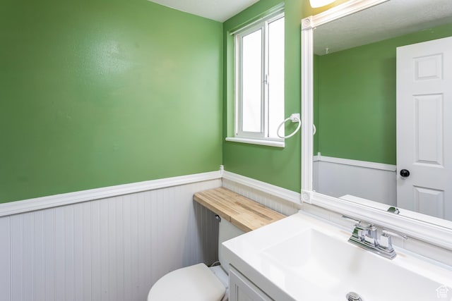 187 E 2300 N, North Ogden, UT 84414 - bathroom featuring vanity, wainscoting, and toilet