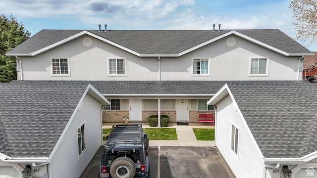 187 E 2300 N, North Ogden, UT 84414 - view of front facade with brick siding, roof with shingles, and stucco siding