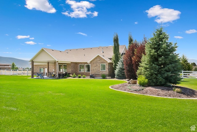 1375 S Red Filly Rd, Heber City, UT 84032 - back of house featuring a mountain view, a yard, a patio area, fence, and brick siding