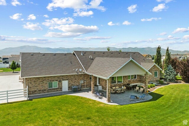 1375 S Red Filly Rd, Heber City, UT 84032 - back of house featuring a mountain view, a yard, a patio area, fence, and a shingled roof