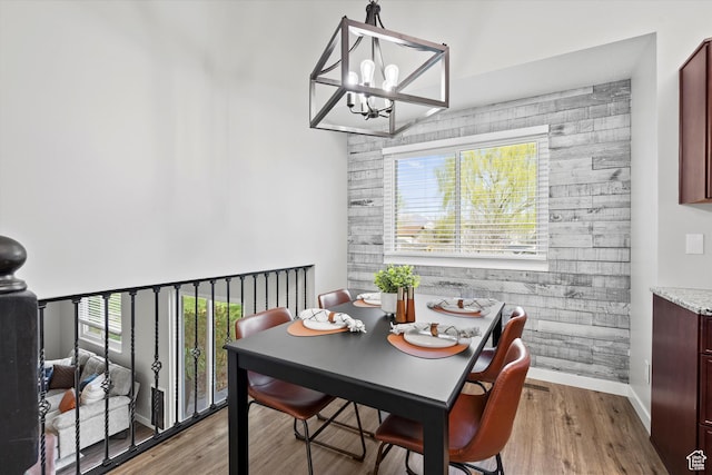 2124 N 2525 W, Clinton, UT 84015 - dining space featuring an accent wall, a notable chandelier, wood finished floors, and baseboards