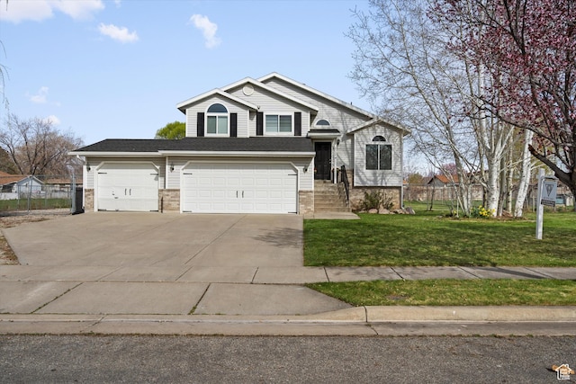 2124 N 2525 W, Clinton, UT 84015 - view of front of house featuring concrete driveway, a garage, fence, and a front lawn