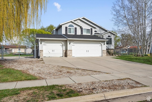 2124 N 2525 W, Clinton, UT 84015 - view of front facade with brick siding, an attached garage, fence, and driveway