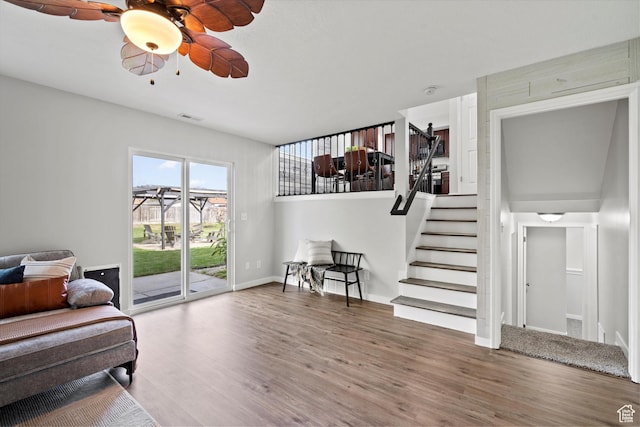 2124 N 2525 W, Clinton, UT 84015 - living area with ceiling fan, visible vents, stairway, wood finished floors, and baseboards