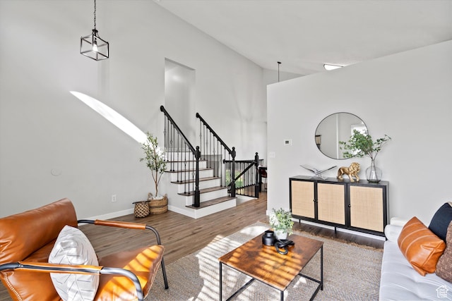 2124 N 2525 W, Clinton, UT 84015 - living area featuring wood finished floors, high vaulted ceiling, baseboards, and stairway